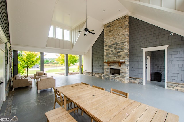 deck with an outdoor living space with a fireplace, a patio, and ceiling fan