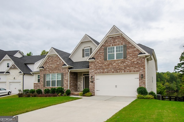 craftsman inspired home featuring a garage and a front lawn