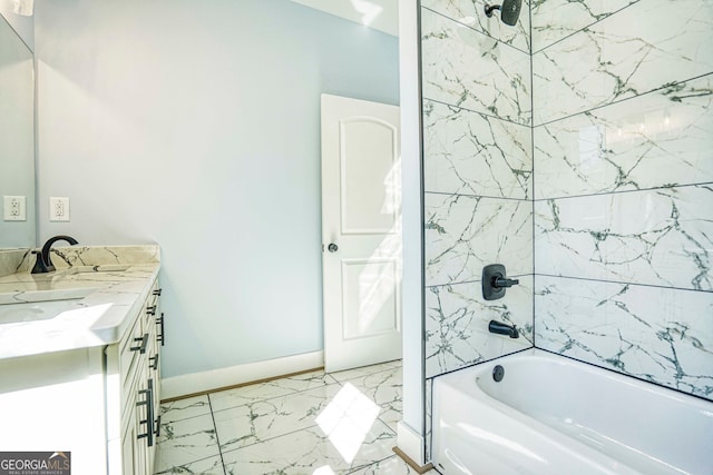 full bath featuring vanity, tub / shower combination, marble finish floor, and baseboards