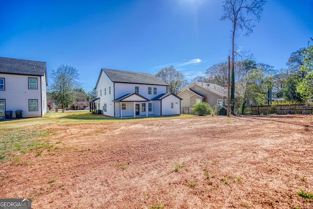 view of front of home with a front yard and fence
