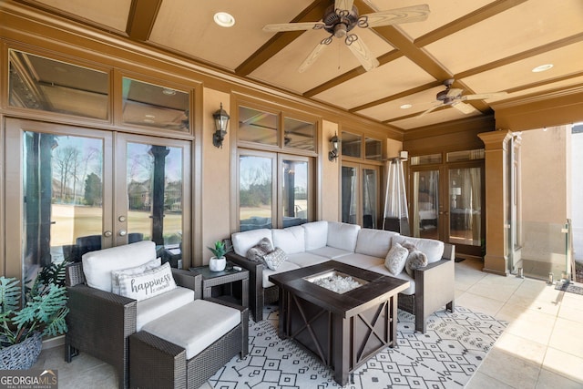 view of patio featuring french doors, ceiling fan, and an outdoor living space with a fire pit