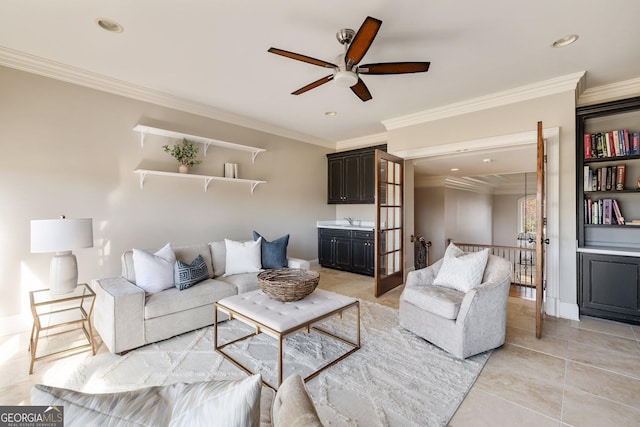 living room featuring light tile patterned floors, sink, and ornamental molding