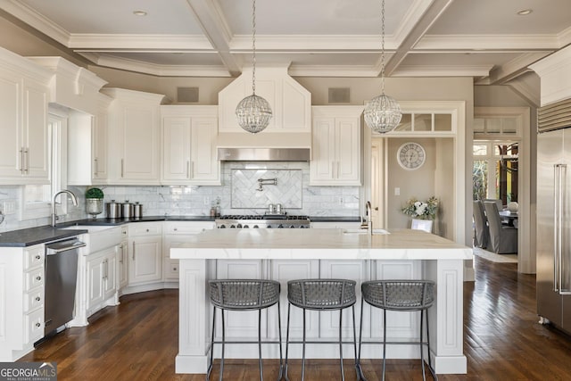 kitchen with sink, white cabinetry, a kitchen island, stainless steel appliances, and dark wood-type flooring