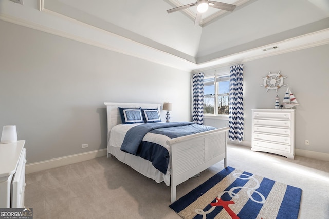 carpeted bedroom featuring a tray ceiling, vaulted ceiling, crown molding, and ceiling fan