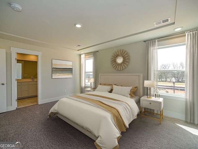 bedroom featuring carpet flooring and ensuite bath