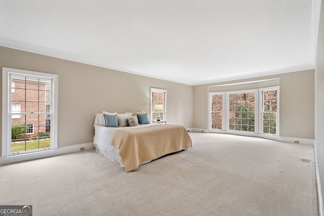 bedroom with baseboards, carpet, visible vents, and crown molding