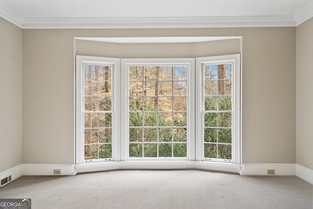 interior space with ornamental molding, carpet, and visible vents