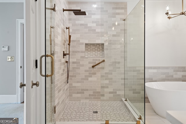 bathroom with a freestanding bath and a shower stall