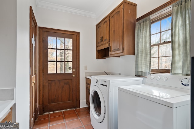 washroom featuring cabinet space, light tile patterned floors, ornamental molding, and washer and clothes dryer