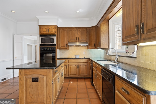 kitchen featuring black appliances, brown cabinets, a sink, and a center island