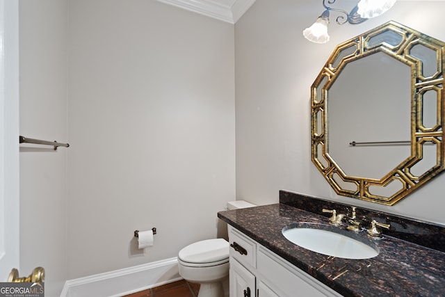 bathroom featuring baseboards, toilet, tile patterned floors, crown molding, and vanity