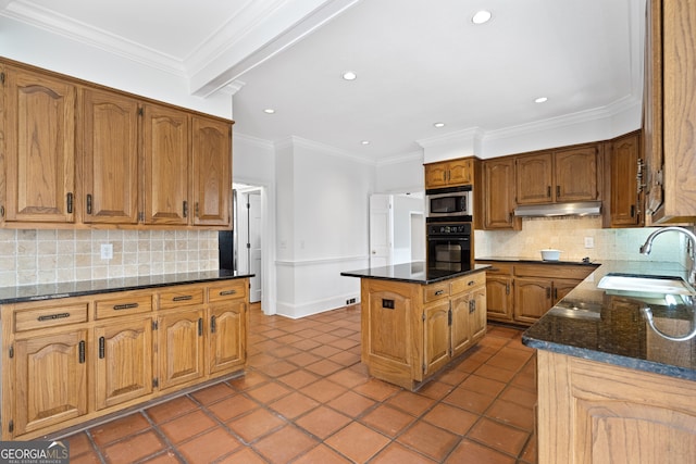 kitchen with oven, under cabinet range hood, a sink, a kitchen island, and stainless steel microwave