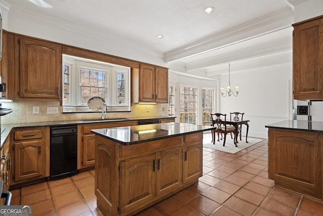 kitchen with brown cabinets, a kitchen island, hanging light fixtures, and a sink