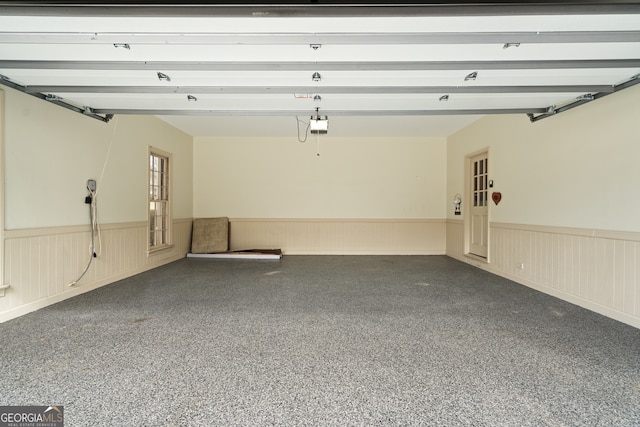 garage with wainscoting and a garage door opener