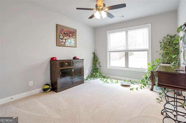 interior space featuring ceiling fan and carpet