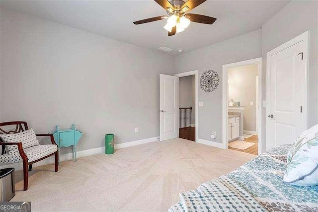 carpeted bedroom featuring connected bathroom and ceiling fan