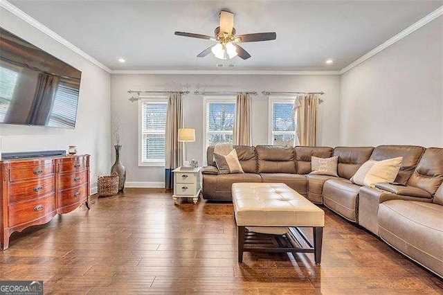 living room featuring a wealth of natural light, dark wood-type flooring, ornamental molding, and ceiling fan