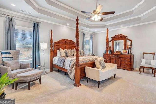 carpeted bedroom featuring ornamental molding, a raised ceiling, and ceiling fan