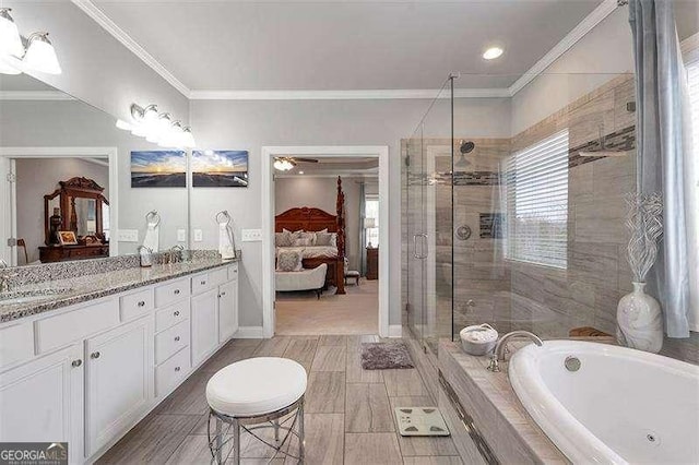 bathroom with vanity, ornamental molding, and independent shower and bath