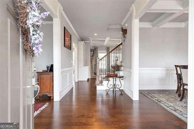 entryway featuring coffered ceiling, beam ceiling, ornamental molding, and dark hardwood / wood-style floors