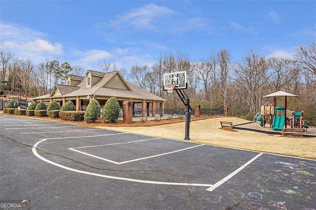 view of sport court featuring a playground