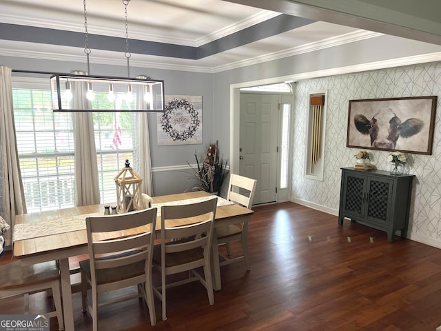 dining space featuring wallpapered walls, baseboards, dark wood-style floors, ornamental molding, and a tray ceiling