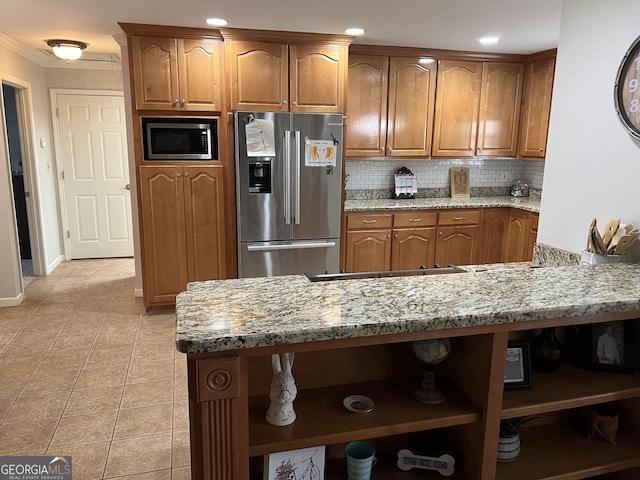 kitchen with brown cabinets, appliances with stainless steel finishes, open shelves, and light stone counters