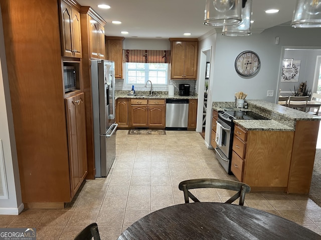 kitchen featuring brown cabinets, stainless steel appliances, decorative backsplash, light tile patterned flooring, and light stone countertops