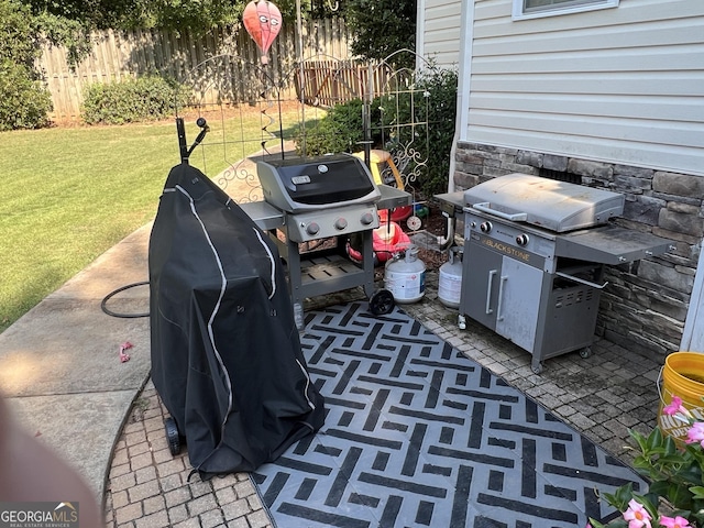 view of patio with grilling area and fence