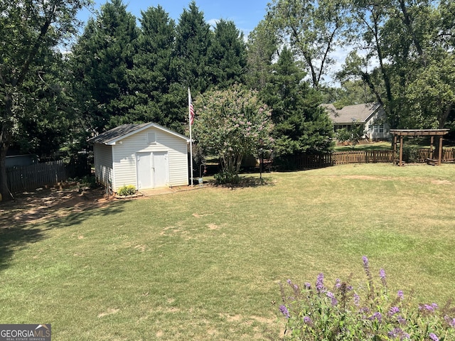 view of yard featuring a fenced backyard, an outdoor structure, and a storage unit