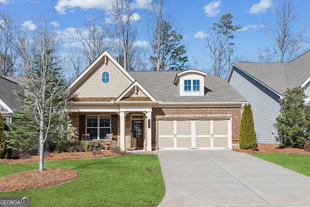 view of front of property featuring a garage, a front yard, and a porch