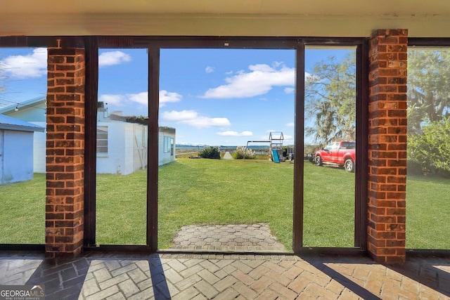 doorway featuring brick floor