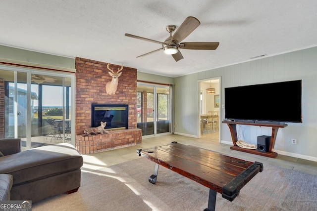 tiled living area with a textured ceiling, ceiling fan, a fireplace, visible vents, and baseboards