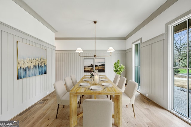 dining space featuring light wood-type flooring and visible vents