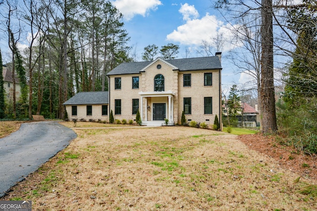 colonial-style house with a front yard