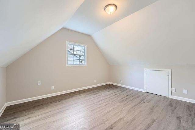 bonus room featuring vaulted ceiling, wood finished floors, and baseboards