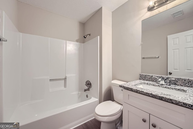 bathroom featuring bathing tub / shower combination, visible vents, toilet, a textured ceiling, and vanity