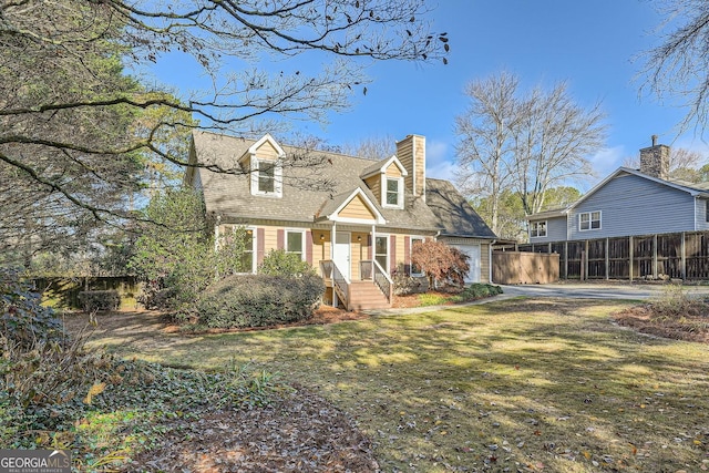 new england style home with an attached garage, a chimney, fence, and a front yard