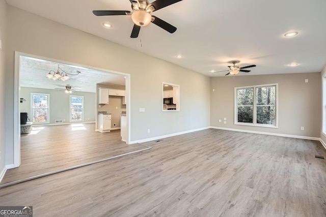 unfurnished living room featuring baseboards, recessed lighting, visible vents, and light wood-style floors