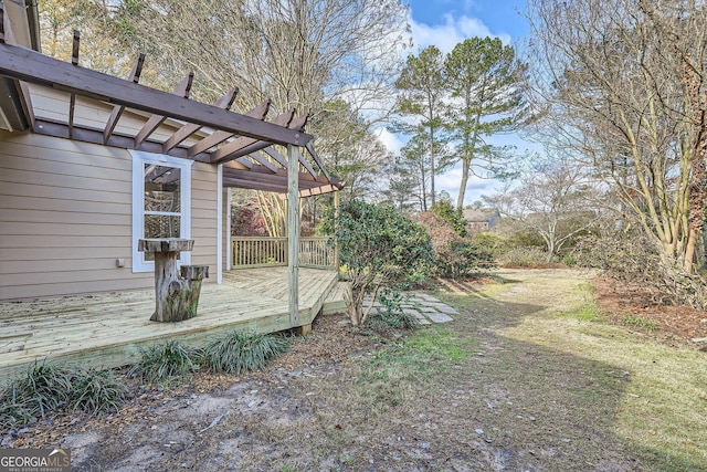 view of yard with a wooden deck and a pergola