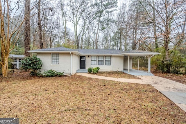 ranch-style home with a front lawn and a carport