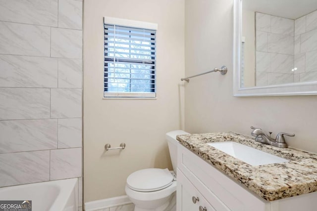 full bathroom with vanity, tiled shower / bath, and toilet