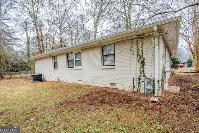 view of side of property with cooling unit and a lawn