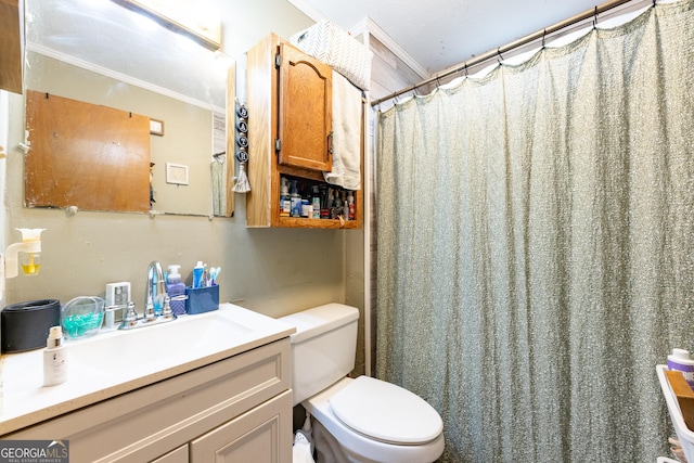 bathroom with a shower with shower curtain, vanity, crown molding, and toilet