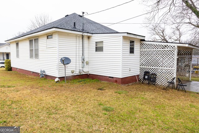 rear view of property featuring a yard