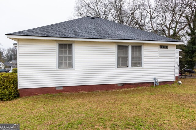 view of side of property with a lawn