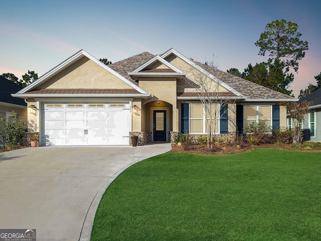 view of front facade featuring a garage and a lawn