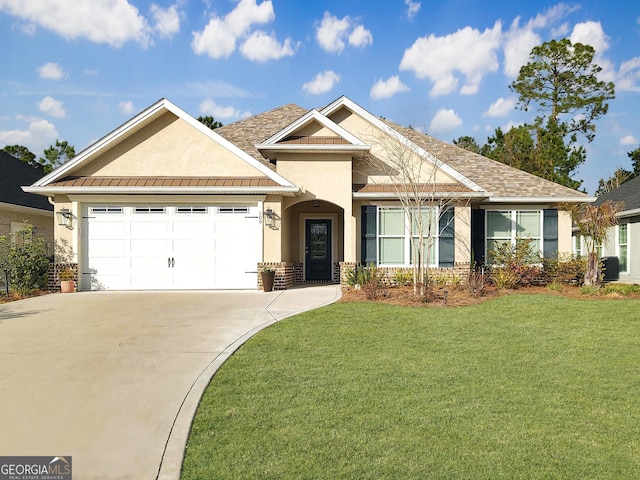 view of front of home featuring a front yard, driveway, stucco siding, a garage, and brick siding