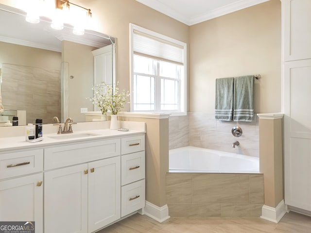 bathroom featuring ornamental molding, tiled bath, and vanity