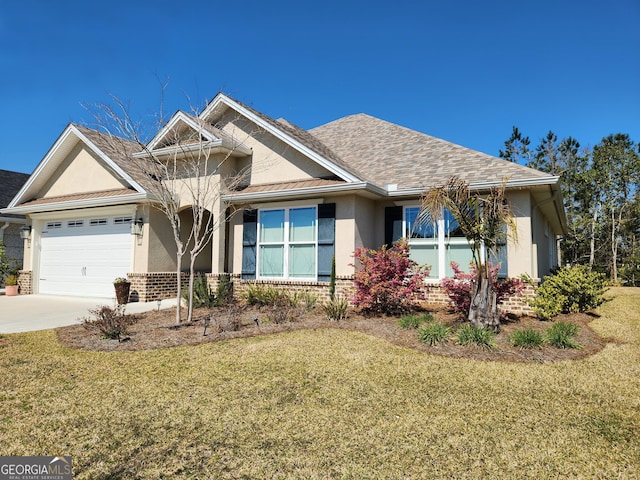 view of front of property with a garage, brick siding, a front yard, and stucco siding